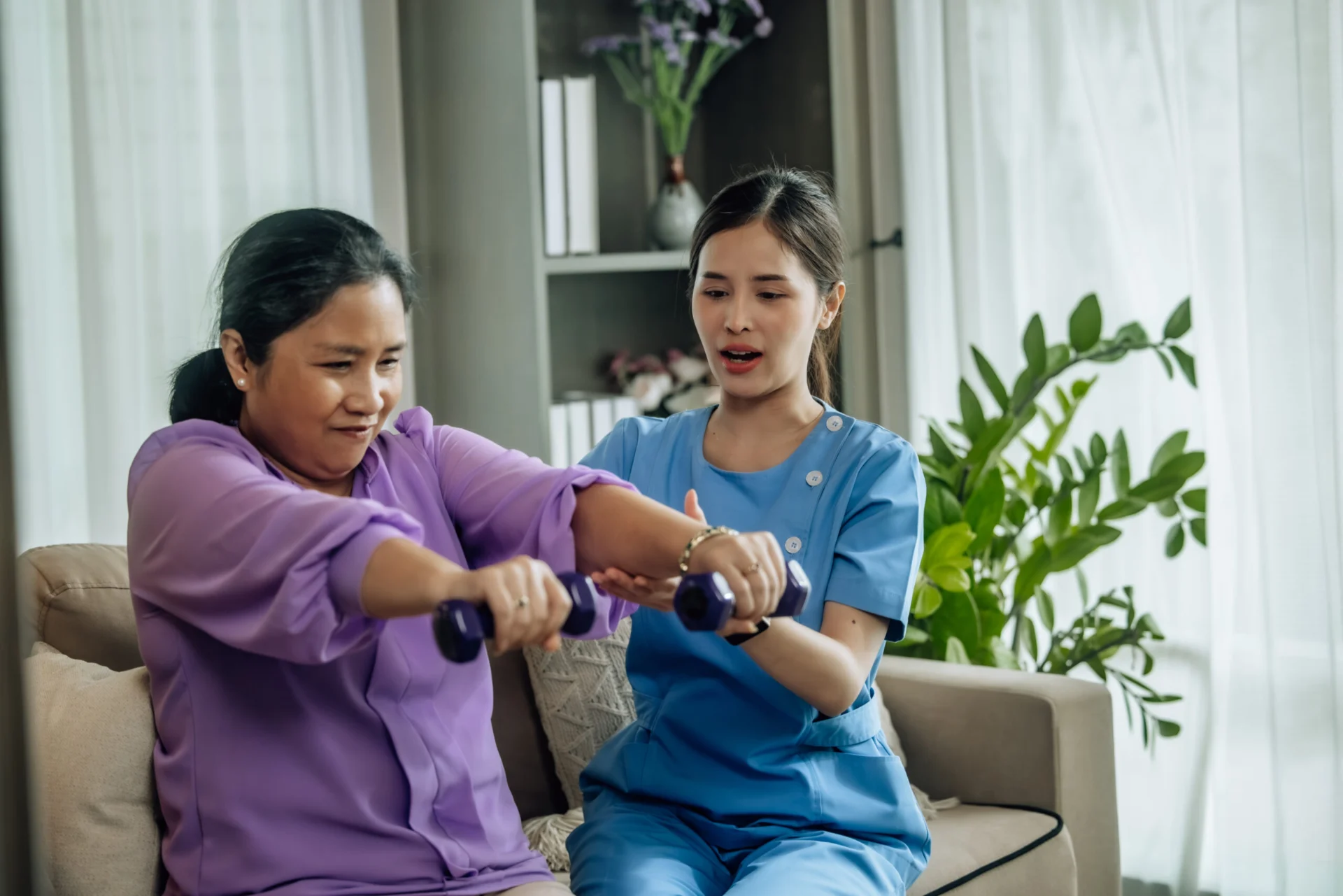 Older woman having therapy to help gain mobility and strength