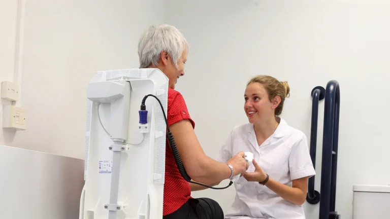 Older lady being helped with physiotherapy