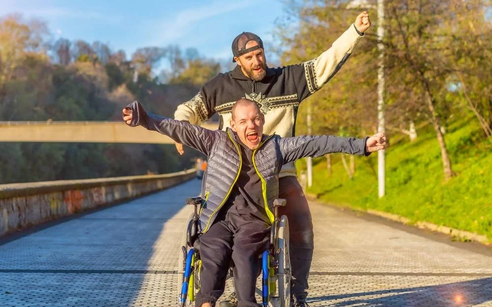 Two men with their hands held high looking happy